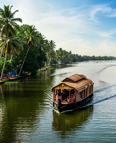 Kerala backwaters with a houseboat and coconut trees